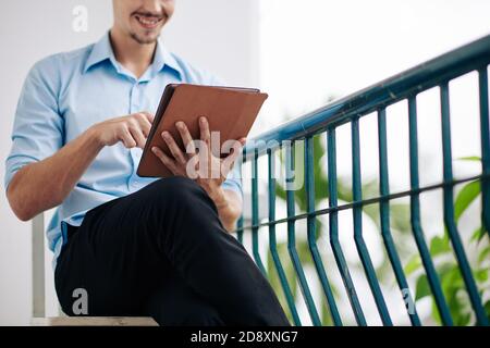 Happy man using app on tablet Stock Photo