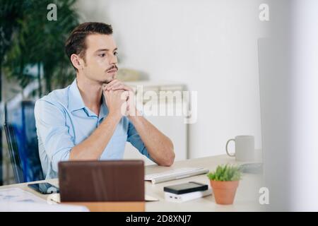 Serious businessman reading report Stock Photo
