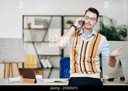 Serious entrepreneur talking on phone Stock Photo