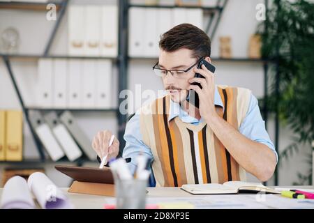 Young engineer calling on phone Stock Photo