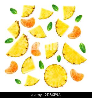 Summer Pattern with Slices of Pineapple Isolated. Exotic fruit Pineapple pieces with green mint leaves on white background. Flat lay. Stock Photo