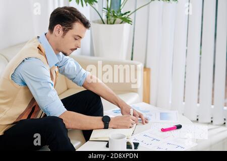 Entrepreneur analyzing financial statistics Stock Photo