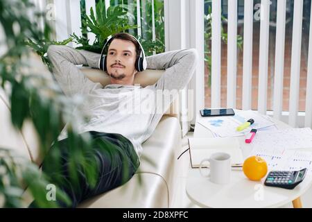 Young man resting on sofa Stock Photo