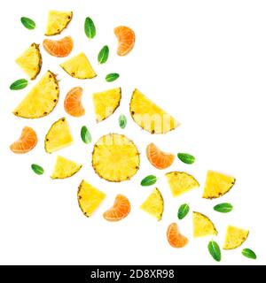 Summer Pattern with Slices of Pineapple Isolated. Exotic fruit Pineapple pieces with green mint leaves on white background. Flat lay. Stock Photo