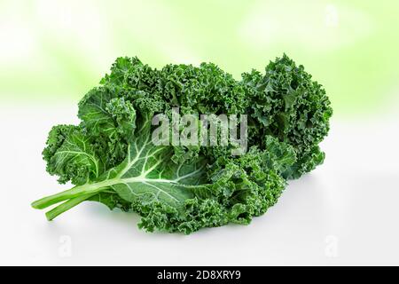 Fresh Kale salad.  Green Kale curly leaves over abstract summer background.  Food concept. Stock Photo