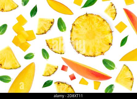 Mango Pattern. Fresh Mangoes pieces with pineapple chunks and leaves isolated on the white background. Stock Photo