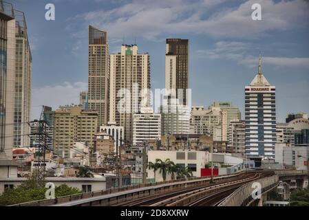 This unique photo shows the skyline of Bangkok in Thailand including the skytrain railroad track in the foreground and the skyscrapers. Stock Photo