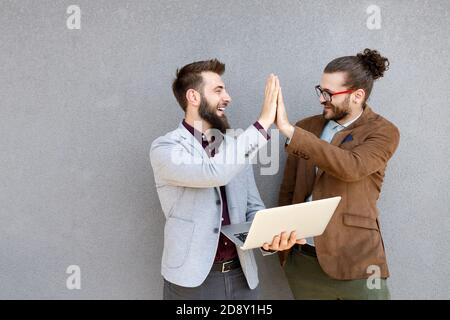 Portrait of happy businessmen using digital devices at meeting Stock Photo