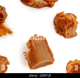 Soft melted caramel Pattern. Golden Butterscotch toffee candy isolated on a white background Macro. Stock Photo