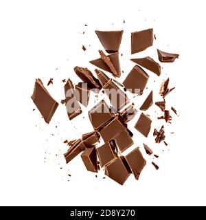 Chocolate pieces and shavings isolated on white background. Chunks of dark chocolate falling close up Stock Photo