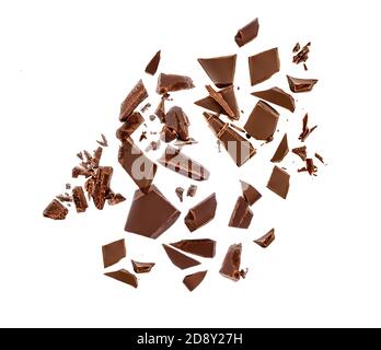 Chocolate pieces and shavings isolated on white background. Chunks of dark chocolate falling close up Stock Photo