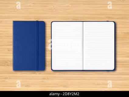 Marine blue closed and open lined notebooks mockup isolated on wooden background Stock Photo
