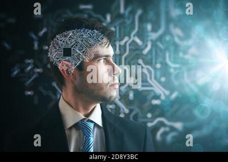 Artificial intelligence concept. Electronic circuit in human brain. Side view of man looking to light. Stock Photo