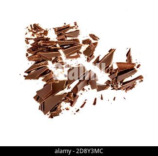 Chocolate broken pieces and shavings isolated on white background. Chunks of dark chocolate falling, top view Stock Photo