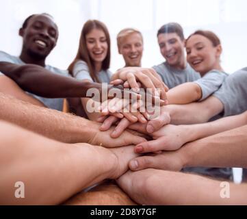 close up. international group of young people putting their hand Stock Photo