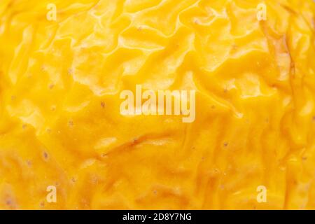 wrinkled texture in the folds of a yellow apple Stock Photo