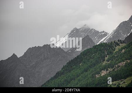 Amazing view of touristic trail near the Matterhorn in the Swiss Alps at cloudy weather Stock Photo