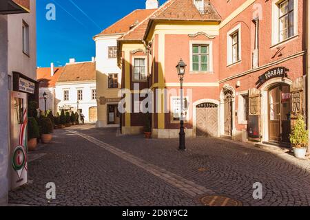 Narrow street with cafe and old houses in the old centre town of Sopron, Hungary Stock Photo