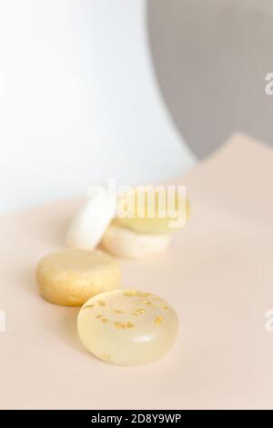 Five bars of natural scented translucent soap in light background. Stock Photo