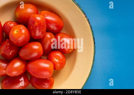 stack of fresh cherry tomatoes against a white background. group of cherry tomatoes isolated on white background Stock Photo