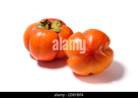 Two Persimmons isolated on white background. Side vew Stock Photo