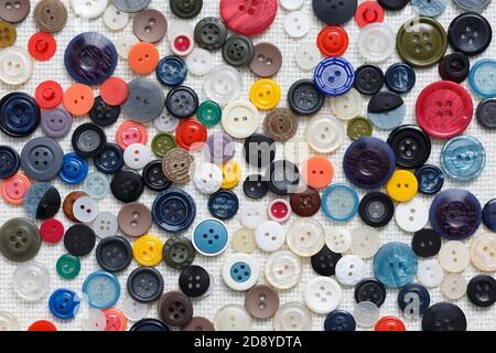 Multicolored buttons on a white woven background Stock Photo