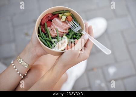 Fresh healthy food in bowl in woman's hands Stock Photo