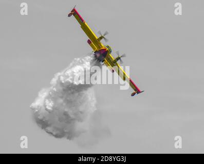 Firefighter Plane Dropping Water in Switzerland. Stock Photo