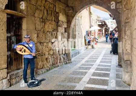 Man playing Oud, a traditional oriental instrument, at the entrance of the old historical Byblos souk market, Jbeil, Lebanon Stock Photo