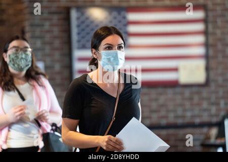 Washington, USA. 28th Oct, 2020. People wait in line to fill out their ballots at a polling center during early voting in Washington, DC, the United States, Oct. 28, 2020. Credit: Liu Jie/Xinhua/Alamy Live News Stock Photo