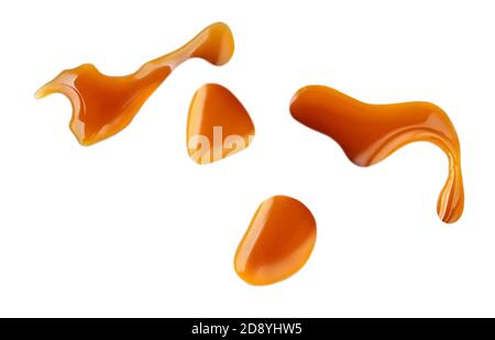 Sweet caramel sauce drops isolated on white background, top view Stock Photo