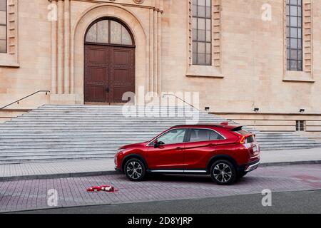 Katowice/Poland - 05.02.2019: Red Mitsubishi Eclipse Cross, city SUV, parked in front of the cathedral. Stock Photo