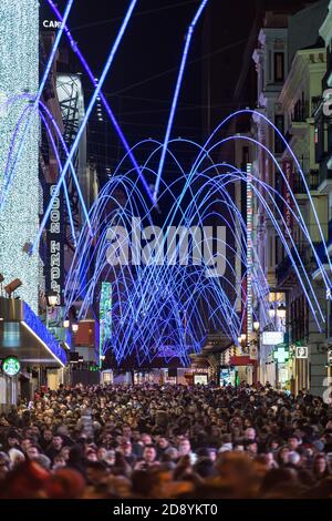 MADRID, SPAIN - JANUARY 4, 2020: Crowds of people gather at the calle Preciados in Madrid under the Christmas lights.