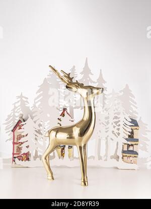 Vertical shot of a golden deer statue with Christmas ornaments isolated on a white background Stock Photo