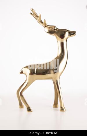 Vertical shot of a golden deer souvenir isolated on a white background Stock Photo