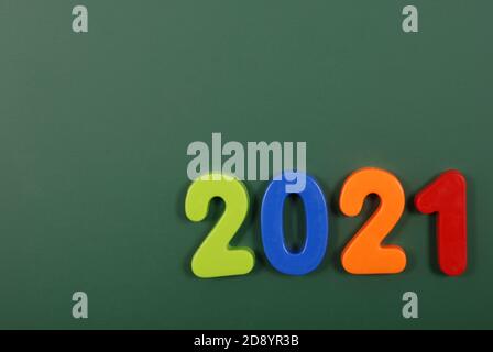 2021 year written in bright plastic magnetic letters stuck on a magnetic board Stock Photo