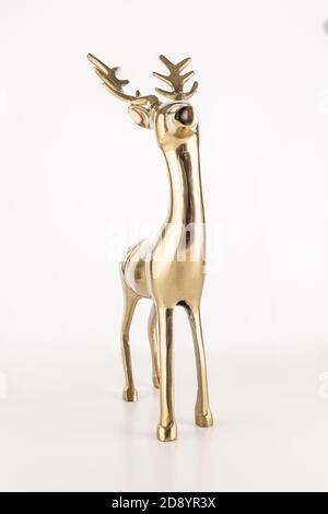 Vertical shot of a golden deer souvenir isolated on a white background Stock Photo