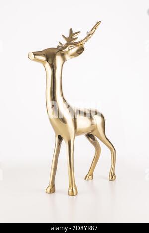 Vertical shot of a golden deer souvenir isolated on a white background Stock Photo