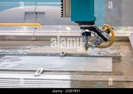 Fast extreme cnc automatic waterjet cutting machine working with sheet metal by high-pressure water jet and abrasive substance. Metalworking Stock Photo