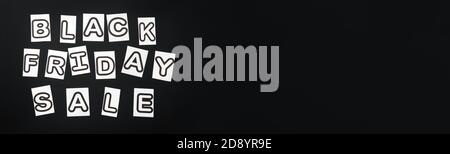 Black Friday sale text lettering on black background. Black and white letters message promotion banner. Long web banner with copy space. Stock Photo