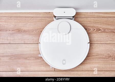 Robot vacuum cleaner return to the charge after cleaning room Modern smart household Stock Photo