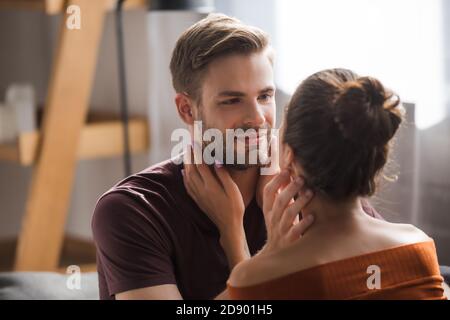 young couple touching each other while standing face to face at home Stock Photo