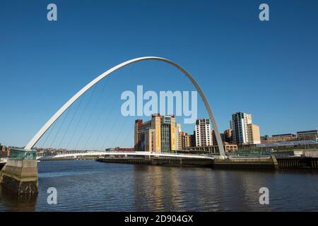 Gateshead Millennium Bridge spanning the River Tyne and the Baltic Centre for Contemporary Art in Tyneside, North East England.