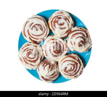 Sweet cinnamon buns from plate on a white isolated background Stock Photo