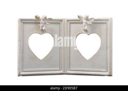White vintage photo frame with angels for two photos in the shape of a heart on a white background Stock Photo