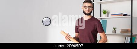 Businessman holding baseball bat in office, banner Stock Photo