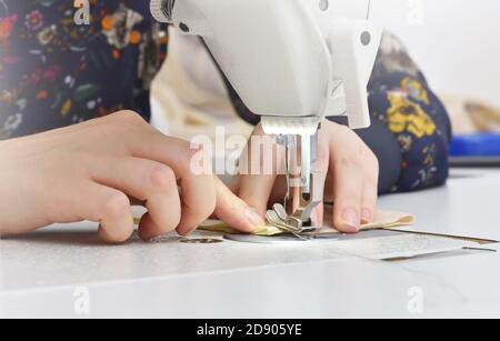 Close up of sewing machine and female hands dressmaker Stock Photo