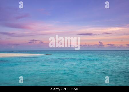 Sunset seascape, dream nature view. Amazing twilight colors, pastel colored sky clouds, calm peaceful sea ocean water. Tranquil relaxing sea sunrise Stock Photo
