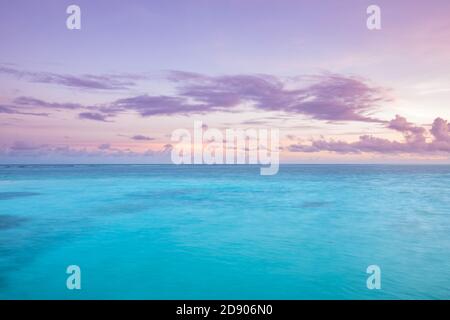 Sunset seascape, dream nature view. Amazing twilight colors, pastel colored sky clouds, calm peaceful sea ocean water. Tranquil relaxing sea sunrise Stock Photo