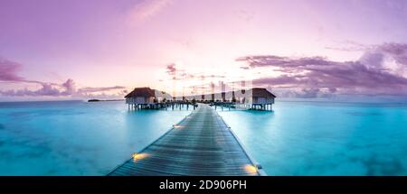 Panorama sunset landscape in Maldives. Beautiful twilight sky and colorful clouds. Beautiful beach background for vacation holiday banner